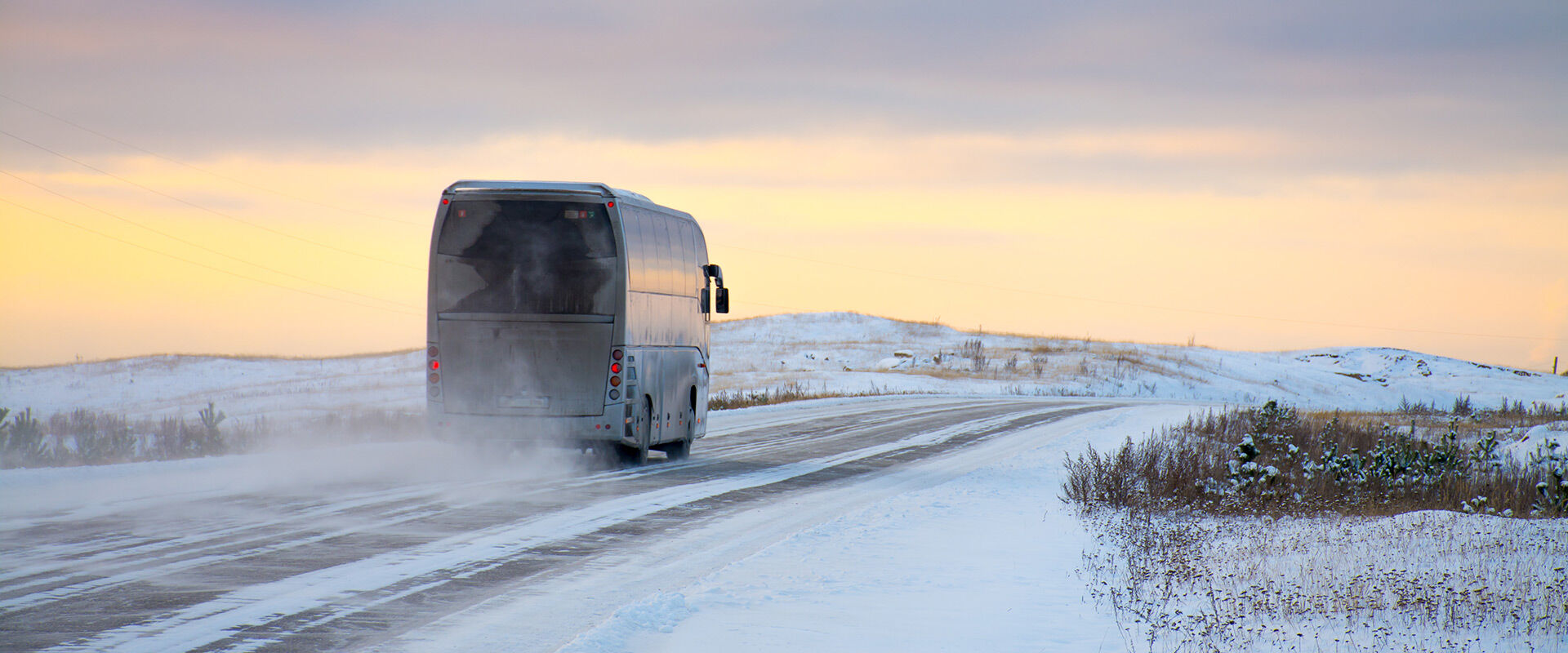 Linja-auto ajamassa talvisella maantiellä