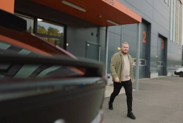 Mies kävelemässä ulos Vianorin palvelupisteestä